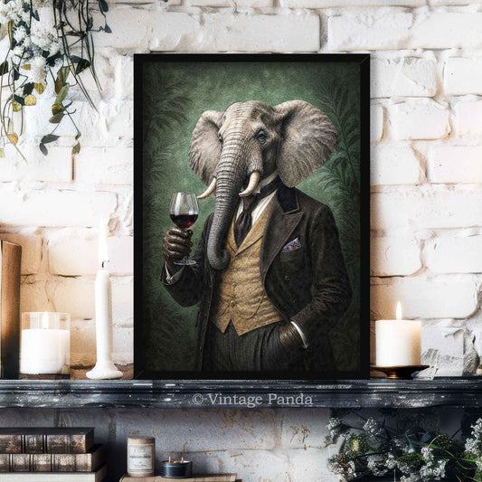 A framed vertical art print of an elephant dressed in a vintage suit and holding a glass of red wine, displayed on a dark mantelpiece against a white brick wall with candles and books.
