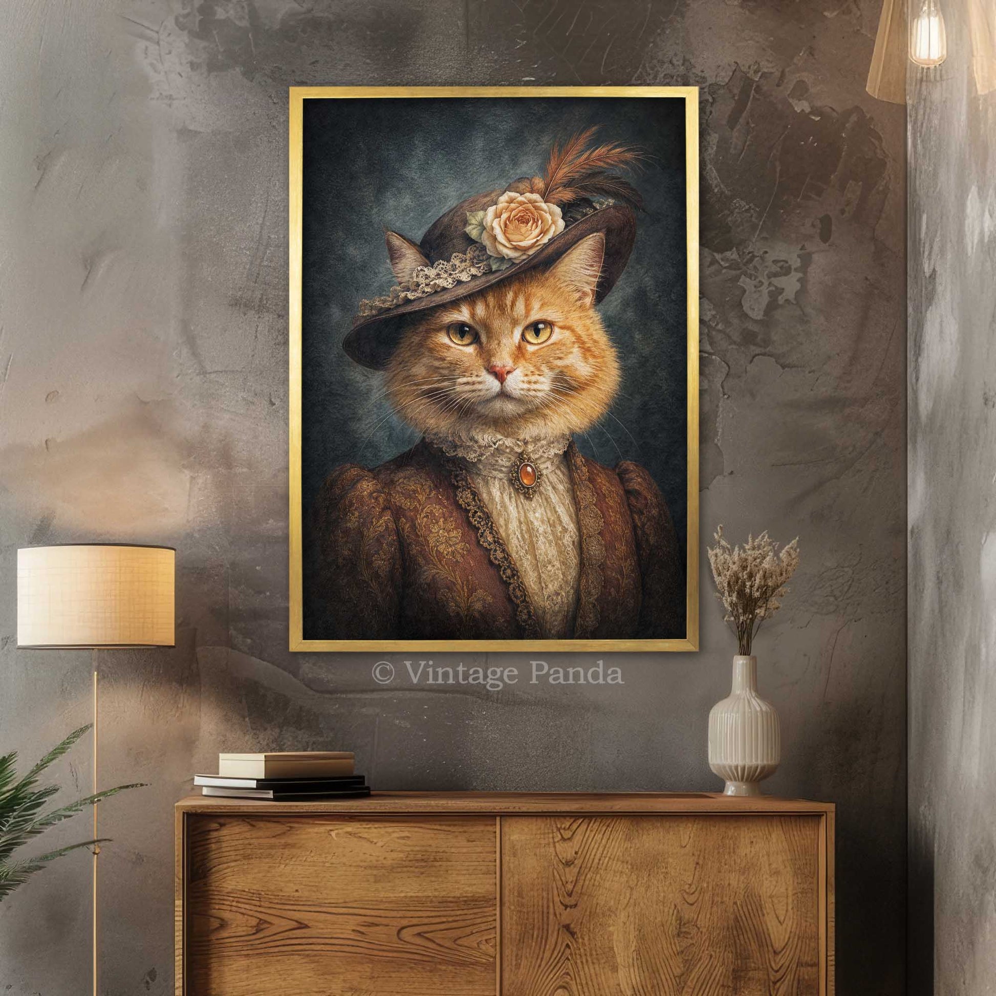 A framed vertical portrait print of a cat dressed in vintage clothing and a hat, displayed on a textured gray wall above a wooden cabinet in a styled interior. The print has a gold frame and the text 'Vintage Panda' appears near the bottom.