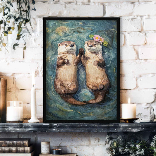 A framed art print depicting two playful otters floating on water holding hands, one with a flower crown, styled on a dark mantelpiece against a white brick wall with candles and books.