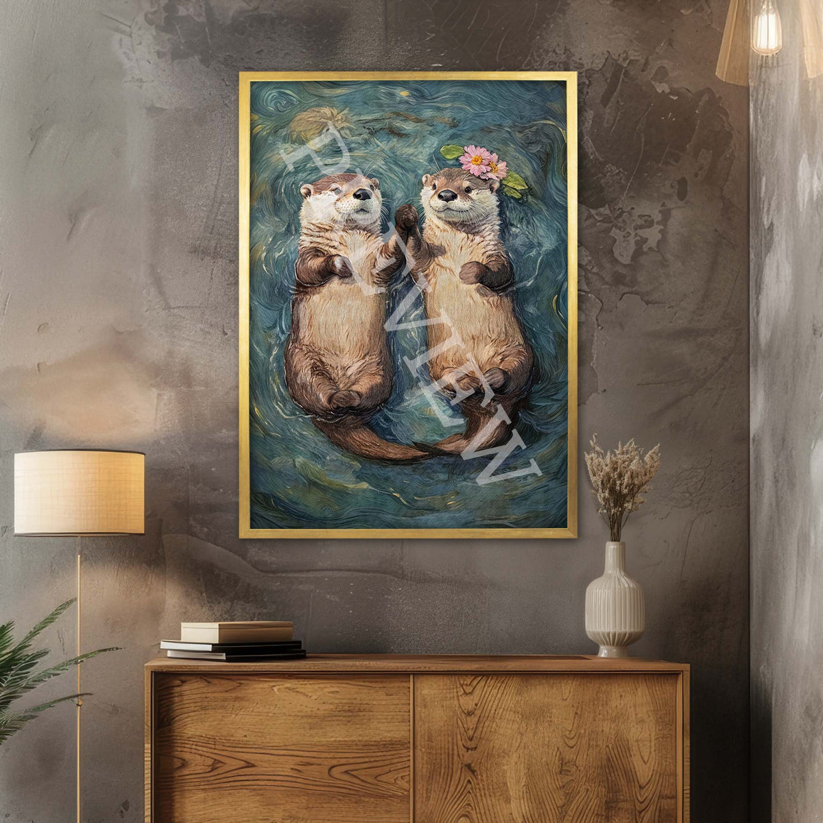 A framed art print depicting two playful otters floating on water holding hands, hung on a textured wall above a wooden console table with a lamp and vase in a styled room setting.