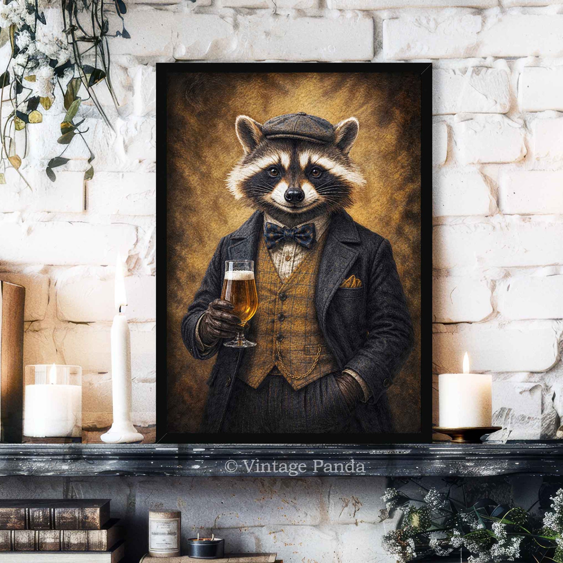 A framed vertical art print depicting a raccoon dressed in a vintage black suit, vest, and bow tie while holding a glass of beer, displayed on a dark mantelpiece against a white brick wall with candles and books.